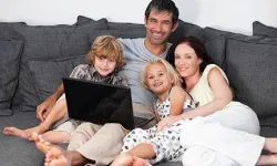 family on a sofa with laptop 0